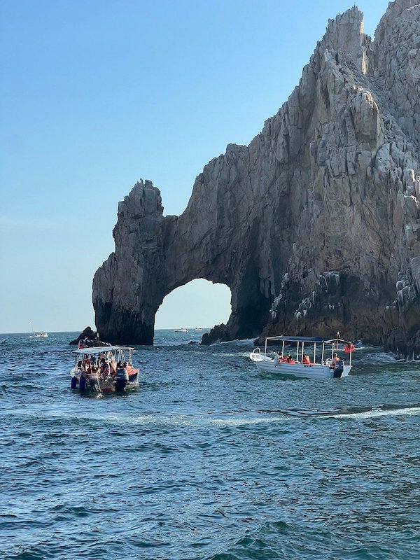 Two small boats in front of El Arco rock formation in Cabo San Lucas.