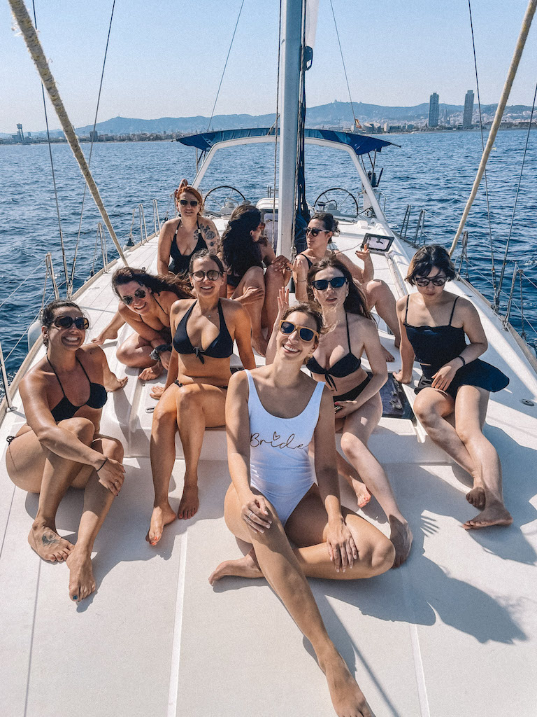 A group of girls sitting on a catamaran 