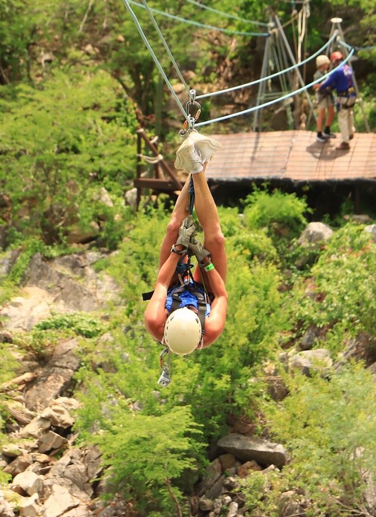 Person ziplining upside down.