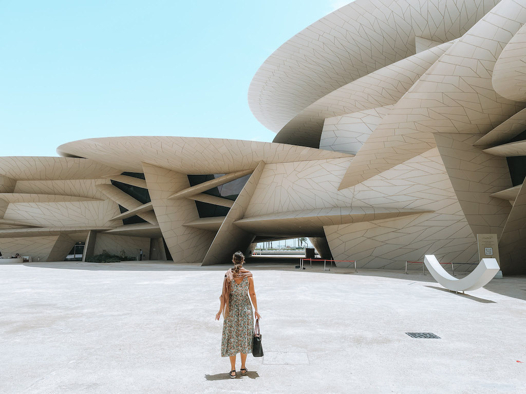 A woman standing outside the National Museum of Qatar