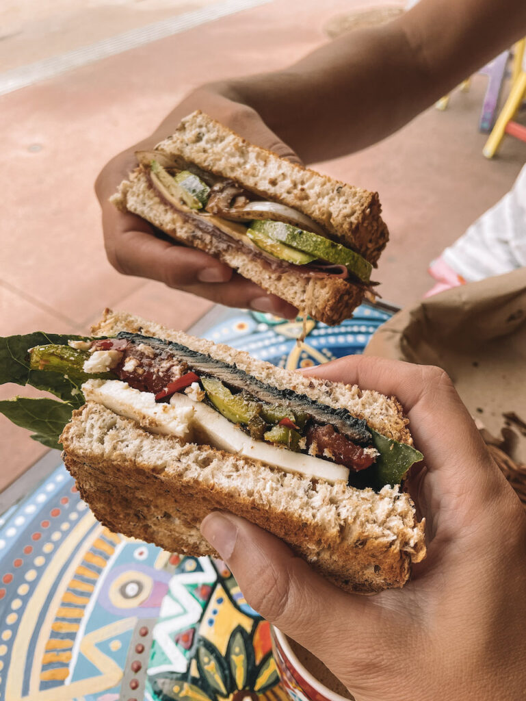 Two hands holding sandwiches