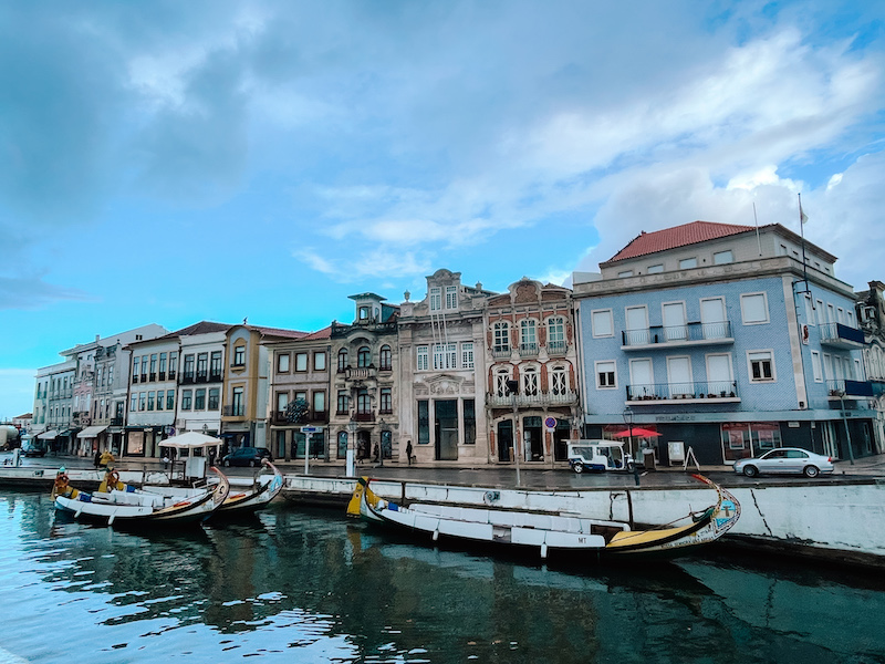 Gondola boats on a river, and elegant buildings in the background