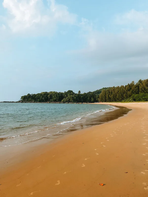 A beach with golden sand and tranquil waters. 