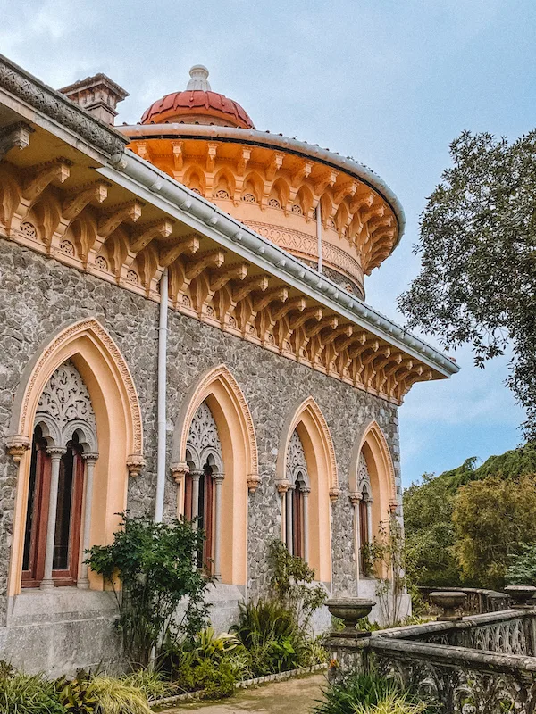 an elegant, intricate building surrounded by vegetation 