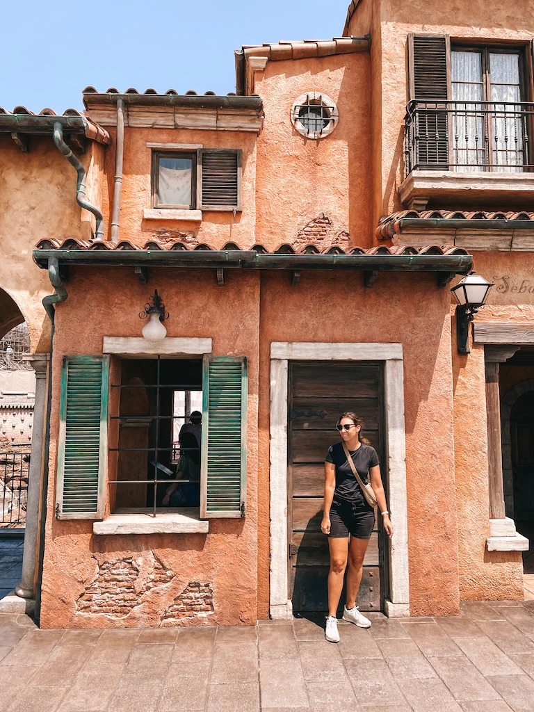 A woman standing in front of a house