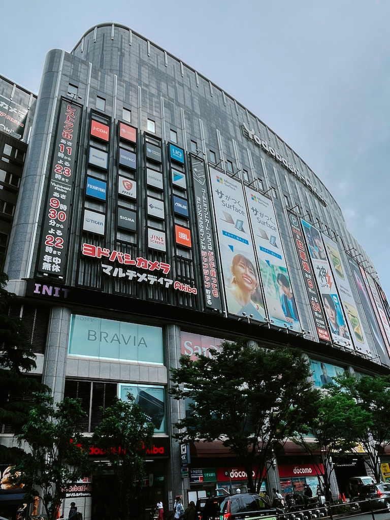 The exterior of a modern building covered in posters