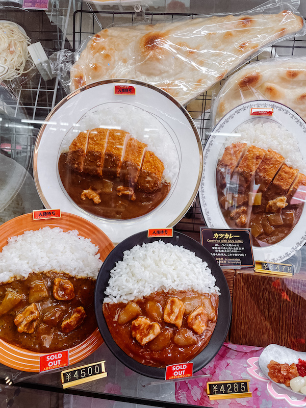 An overhead shot of several plastic plates with plastic food on them