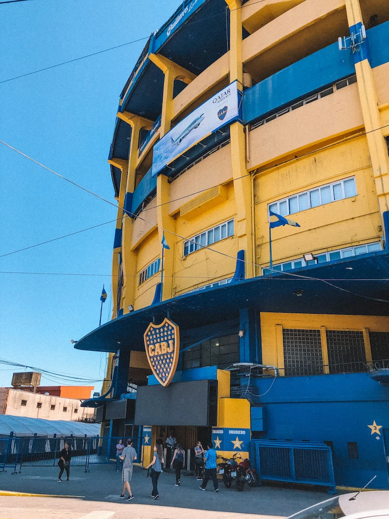 A yellow and blue building with the logo of Boca Juniors Football Club 