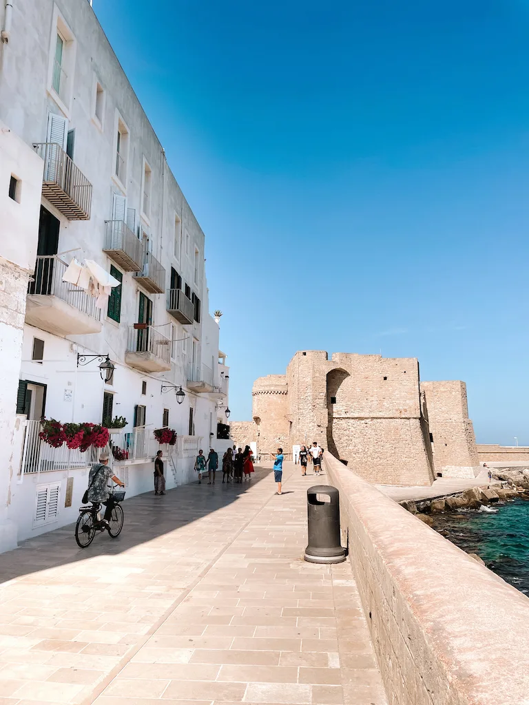 the lungomare in Monopoli, lined by white houses on the left and the sea on the right 