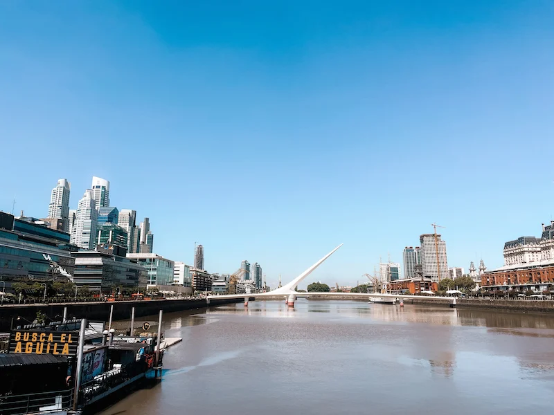 A landscape of Puerto Madero in Buenos Aires, with a bridge crossing a canal, and buildings on both sides