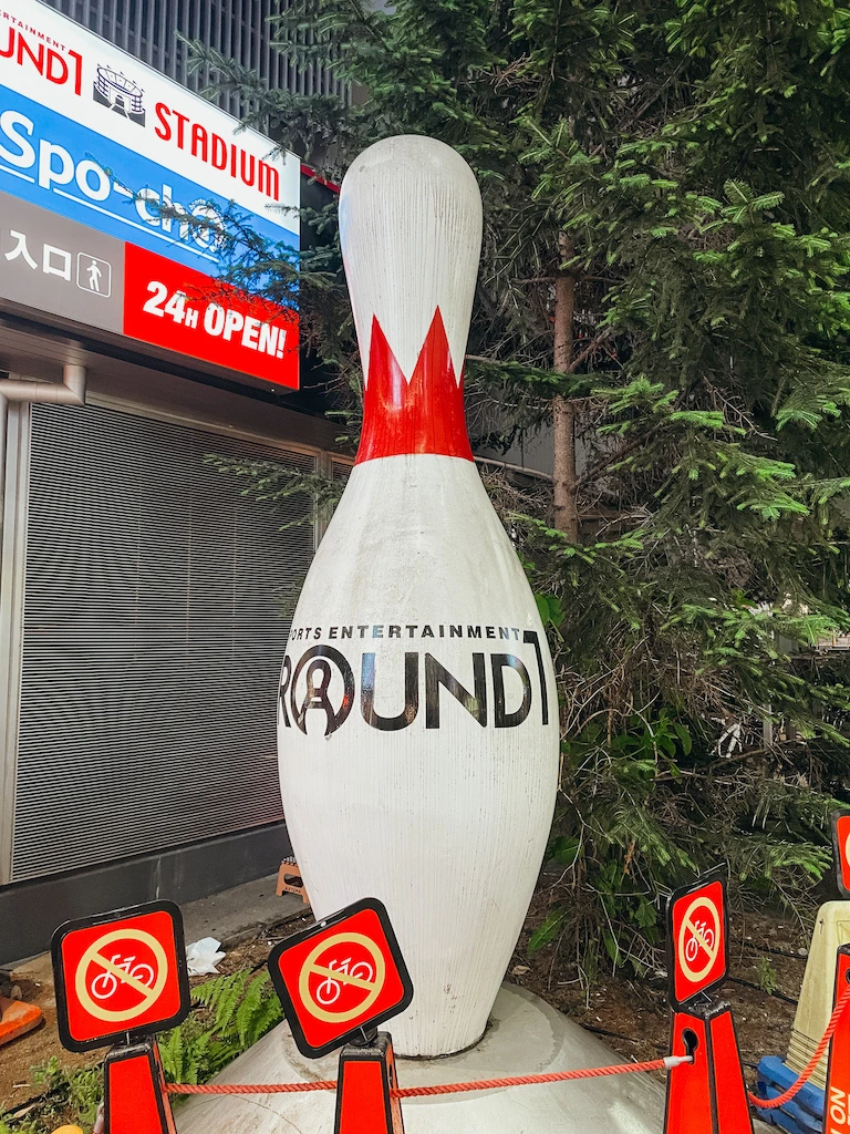 A giant red and white bowling pin