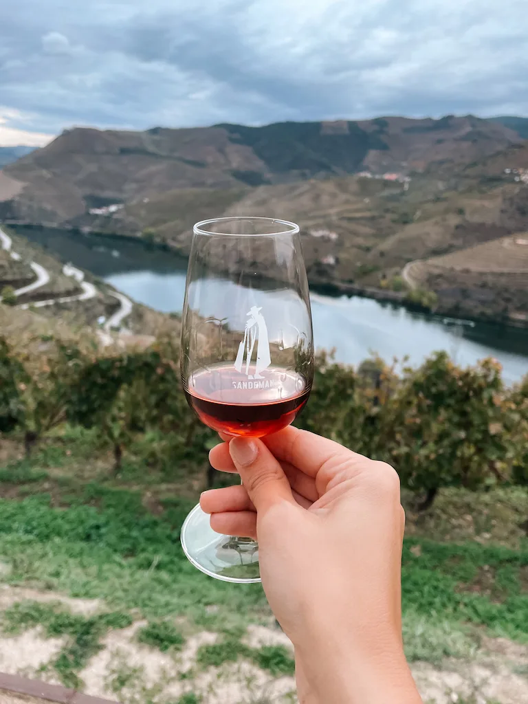 A woman's hand holding a wine glass