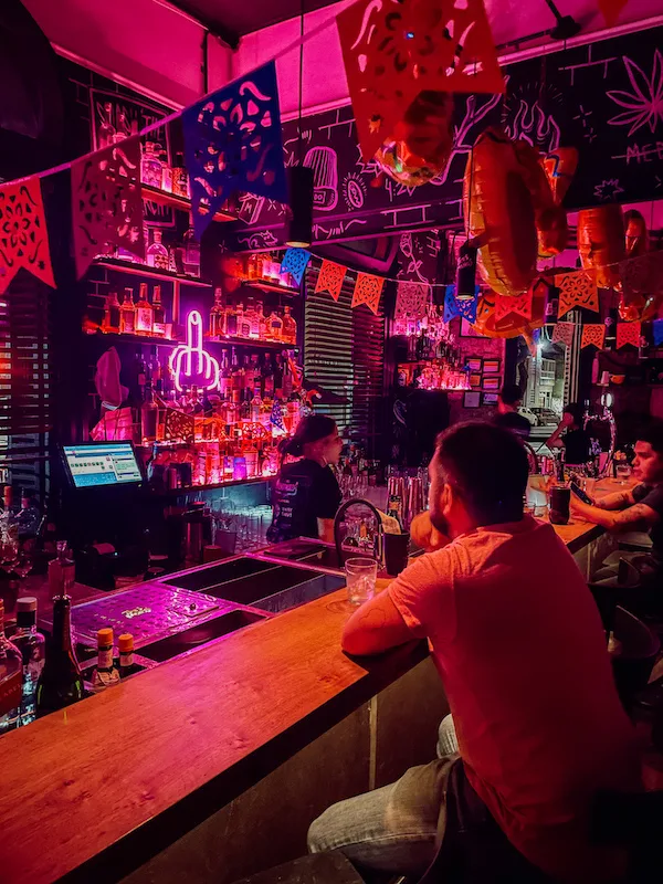 A bar with pink lights and decorations