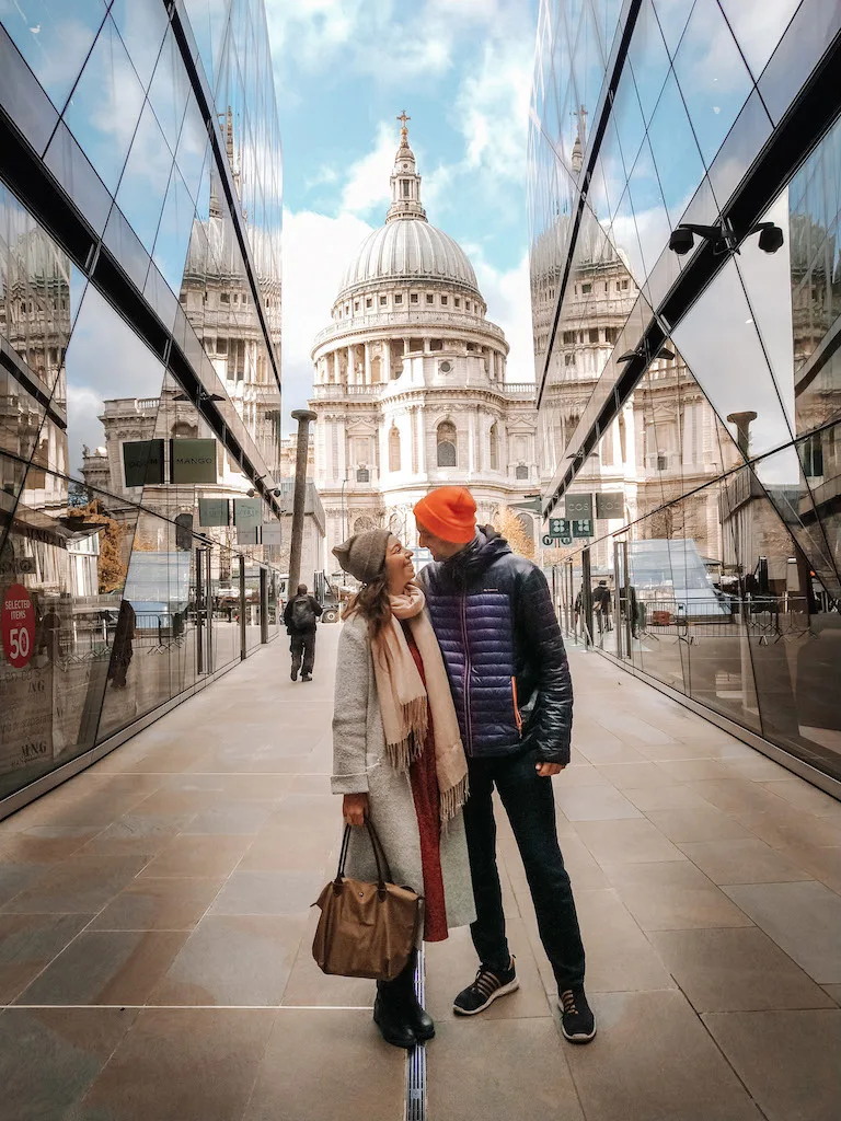 A couple standing in front of the St Paul's Cathedral in London