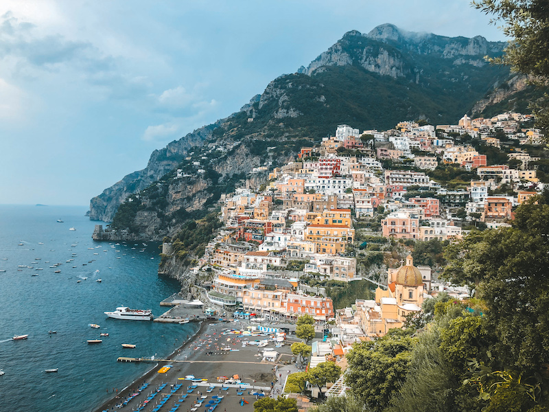 The town of Positano against a mountain, and the beach and sea below